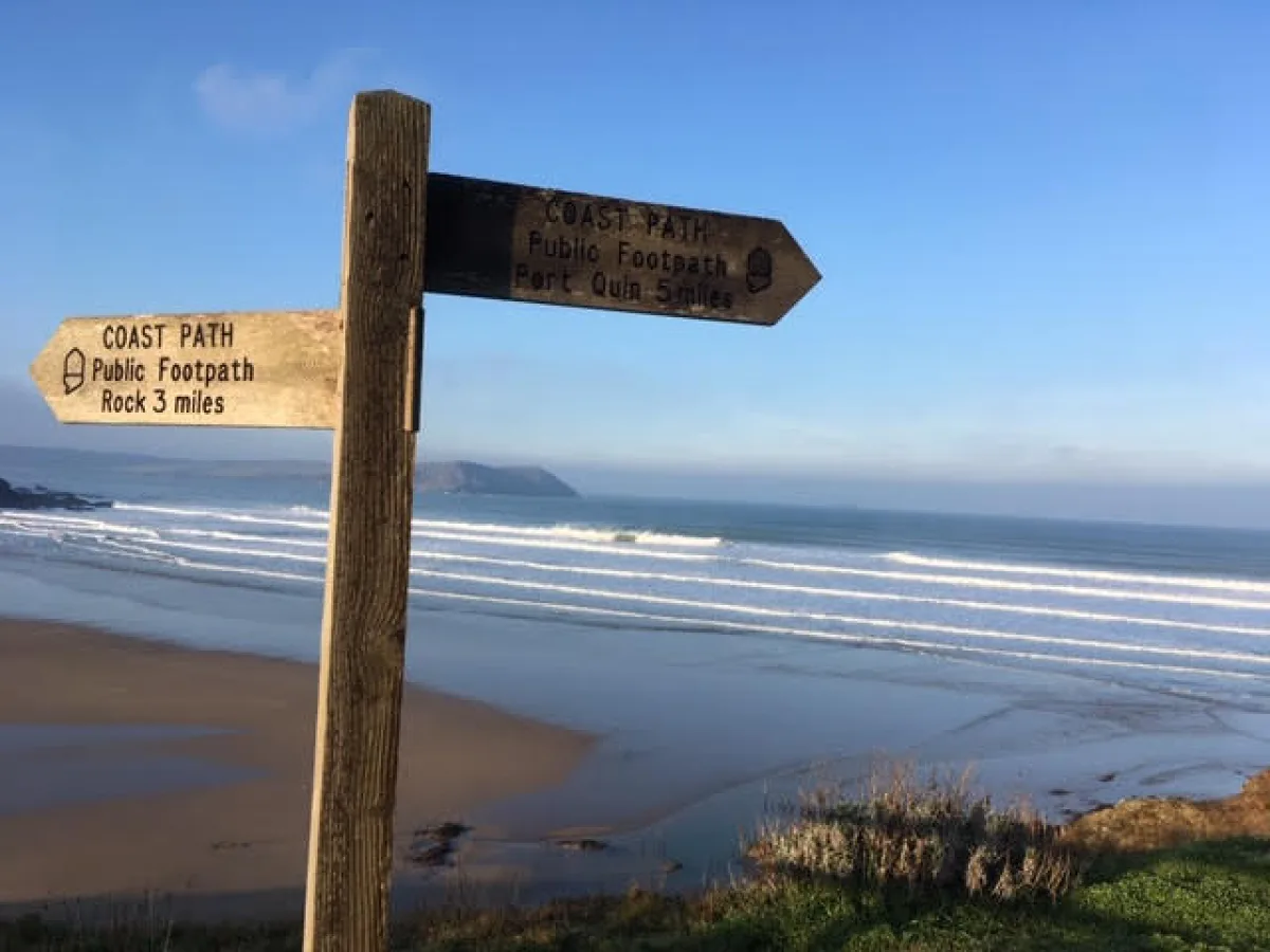 Coast path sign overlooking Polzeath Beach